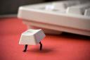 Escape key photo of key with legs escaping