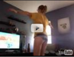 Girl doing hula hoop on with the Nintendo Wii