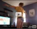 Girl doing hula hoop on with the Nintendo Wii
