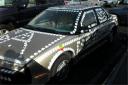 Guy covers car in Apple stickers