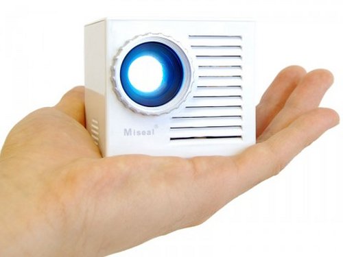 Miniature cube projector with docking speaker
